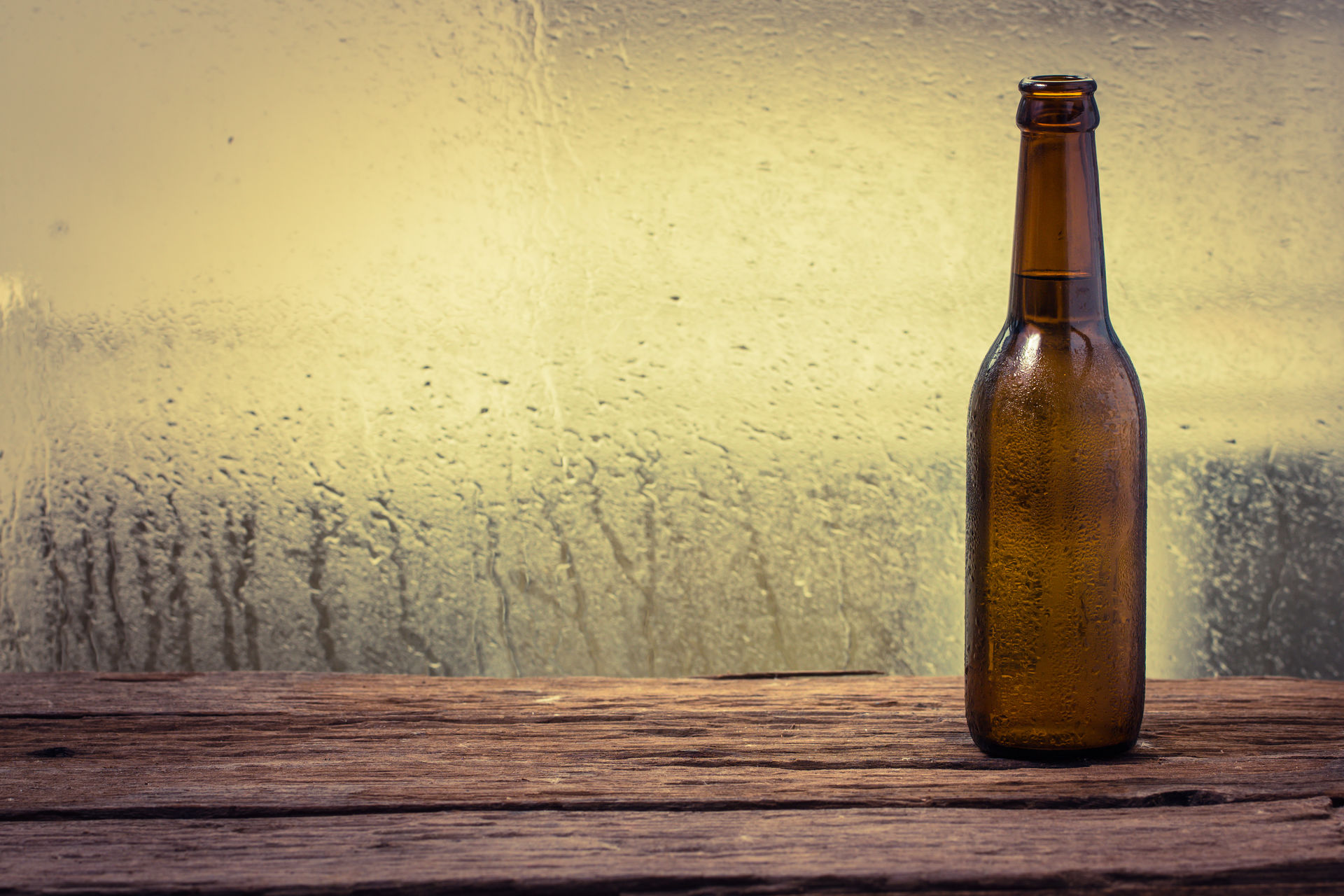 Brown glass bottle sitting on a window ledge