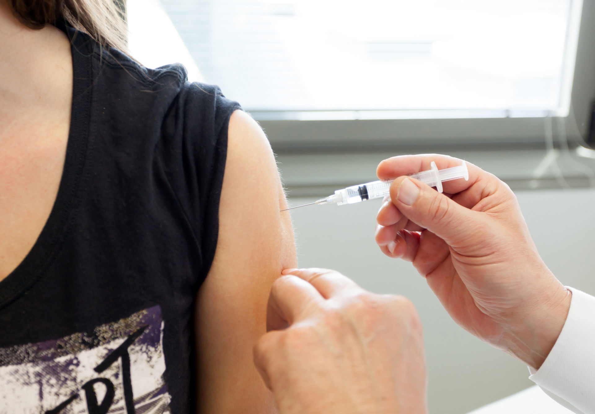 Female receiving contraceptive injection